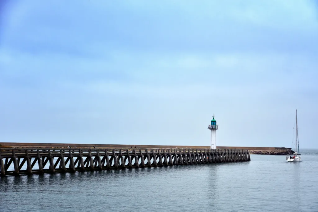 a light house sitting on top of a wooden pier