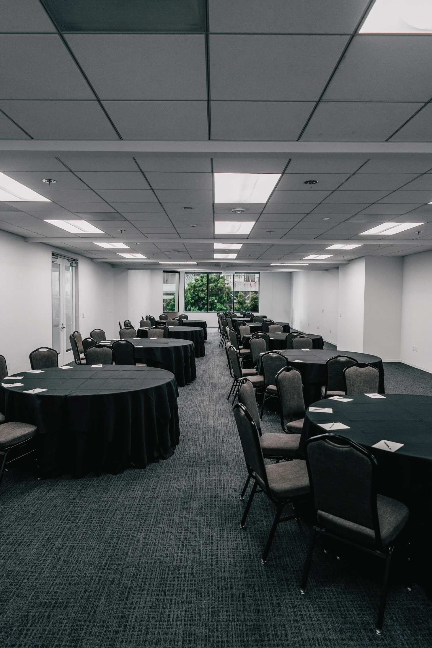 a conference room with round tables and chairs