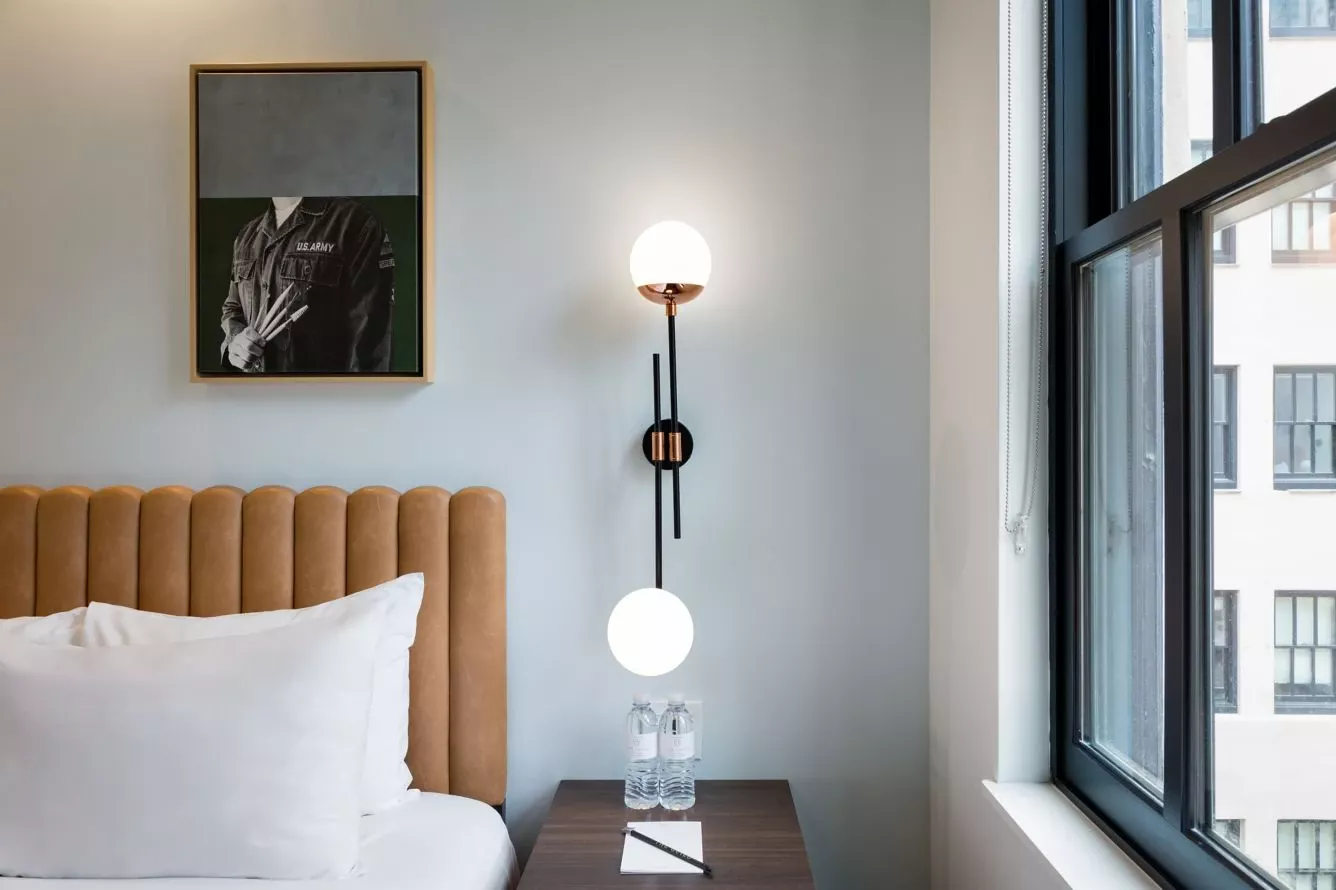 a hotel room with a bed and a large window