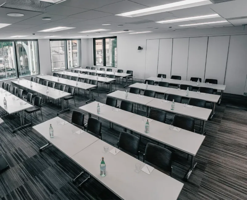 an empty classroom with tables and chairs in it