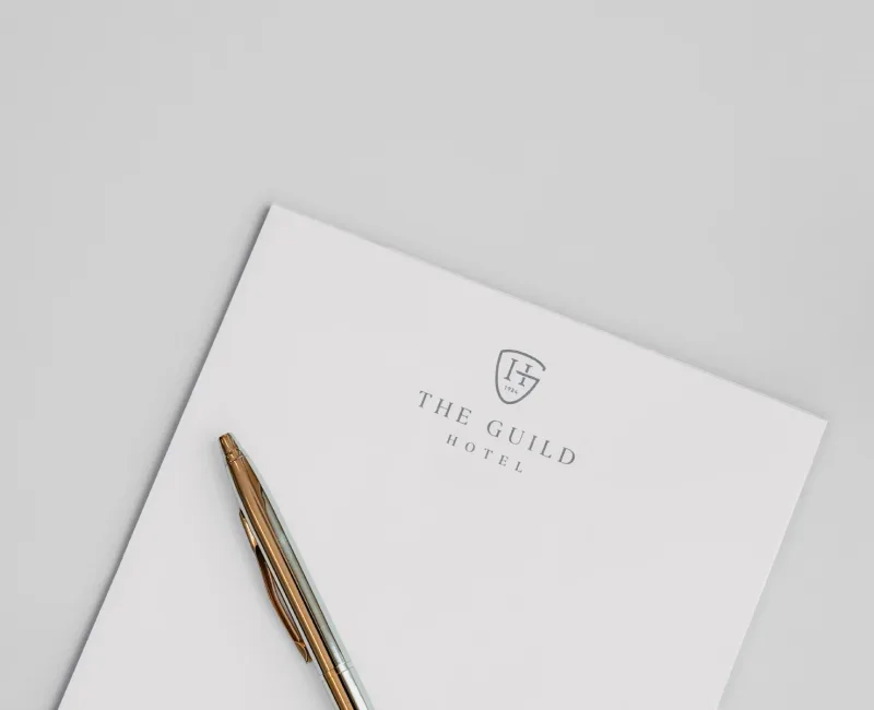 a notepad with a pen sitting on top of it
