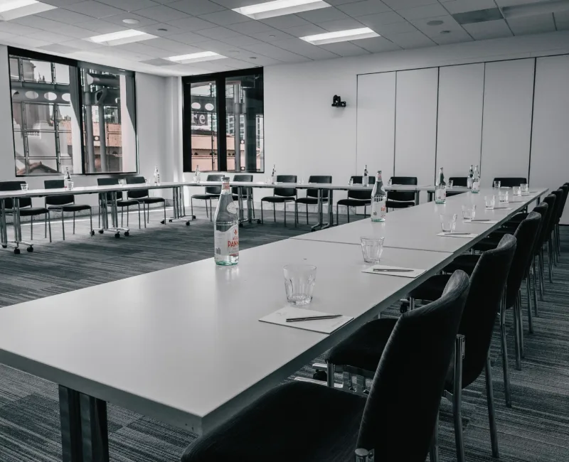 a long table with empty wine glasses on it