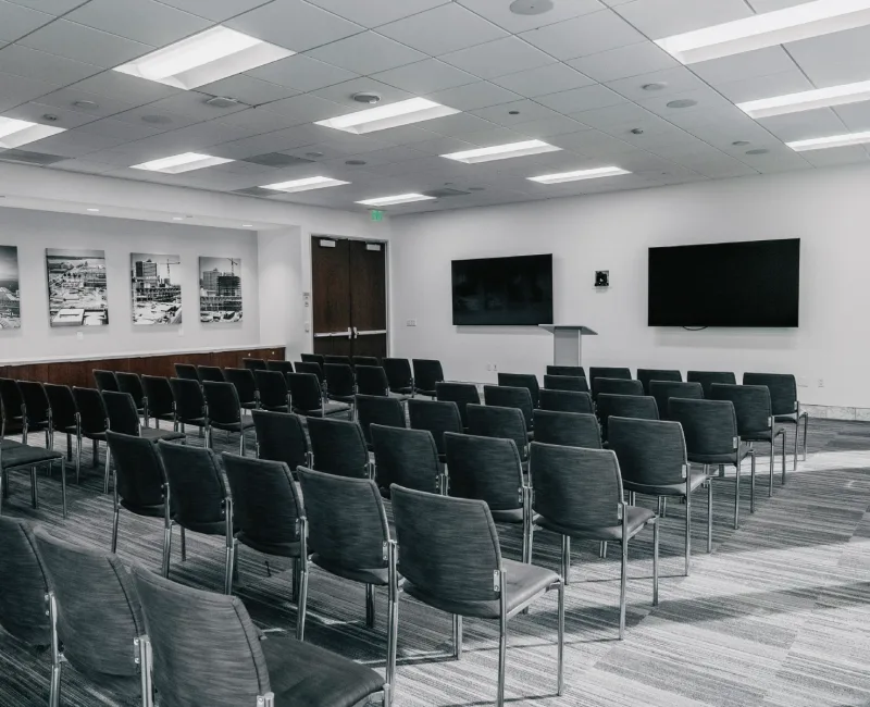 an empty conference room with chairs and a podium
