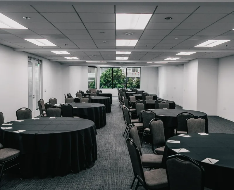 a conference room with round tables and chairs